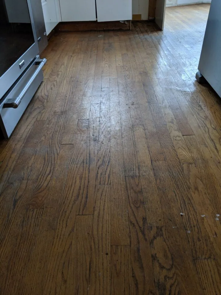 Before and after hardwood floor refinishing in Kitsilano home